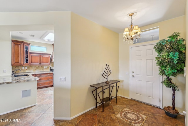 entryway featuring a notable chandelier and sink