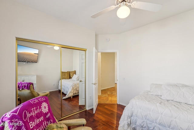 bedroom with a closet, ceiling fan, and dark hardwood / wood-style floors