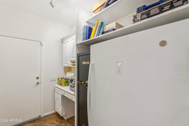 clothes washing area featuring dark tile patterned floors