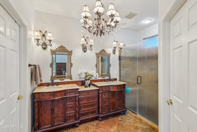 bathroom featuring vanity, a shower with shower door, and a chandelier