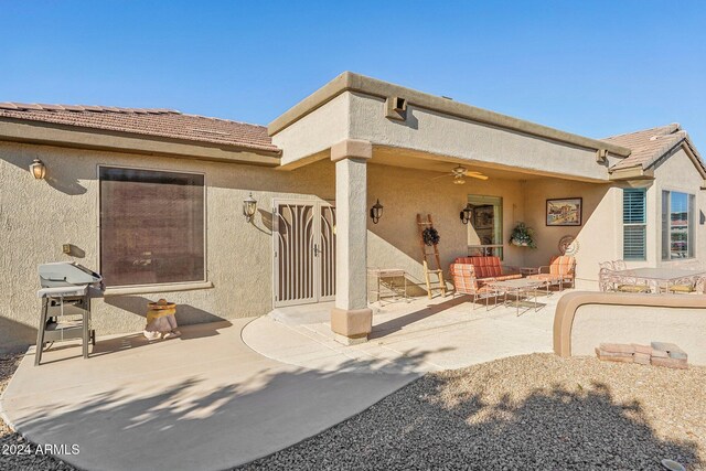 back of house featuring ceiling fan and a patio area