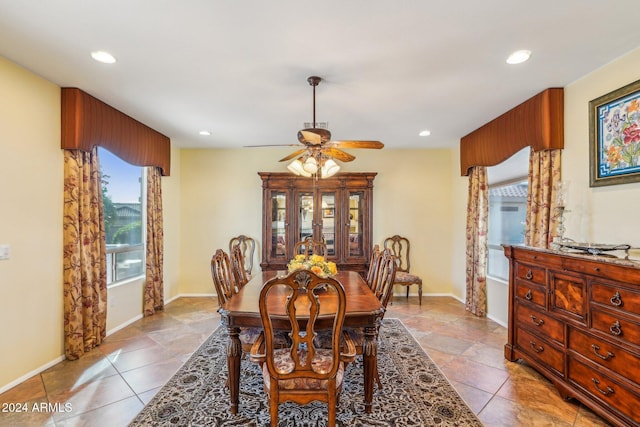 tiled dining space featuring ceiling fan