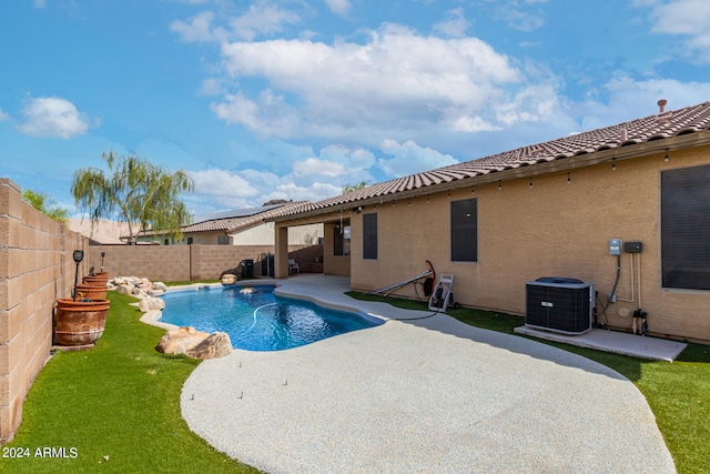 view of pool with a patio area and cooling unit