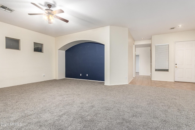 spare room featuring ceiling fan and light colored carpet