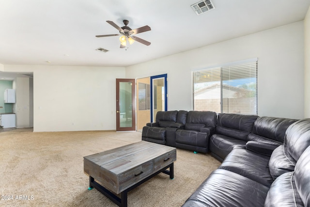 living room featuring light carpet and ceiling fan