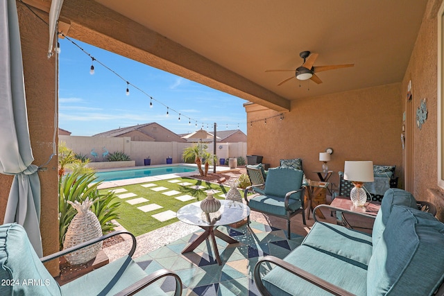 view of patio with a fenced in pool and ceiling fan