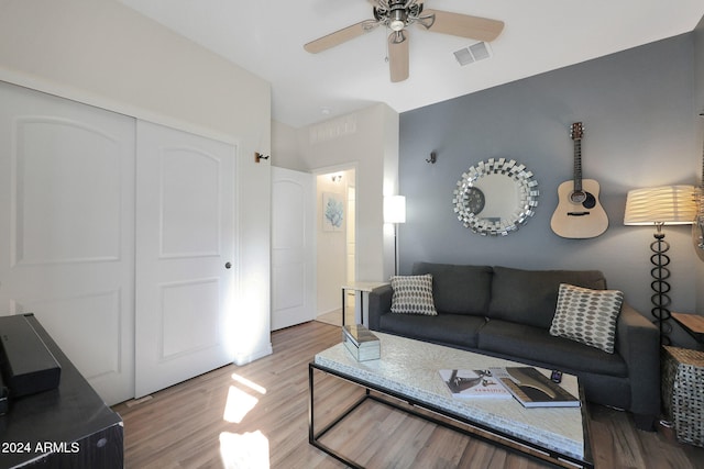 living room featuring wood-type flooring and ceiling fan