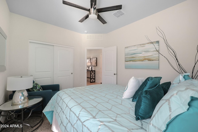 carpeted bedroom with a closet and ceiling fan