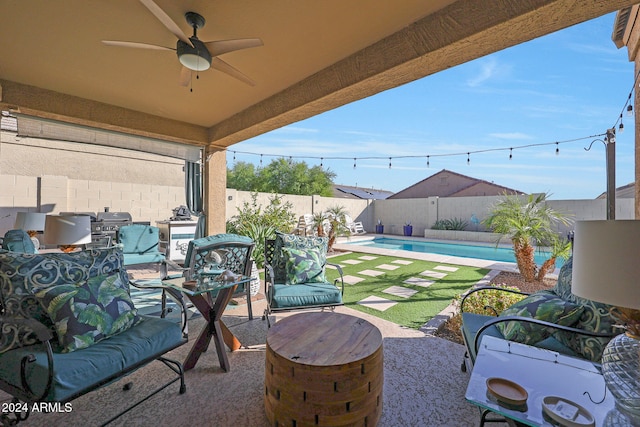 view of patio / terrace with a fenced in pool and ceiling fan