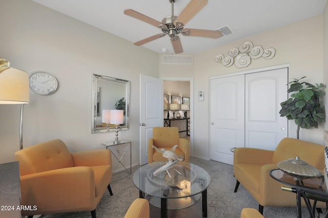 living room with ceiling fan and carpet floors