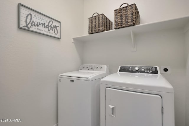 laundry area featuring washing machine and clothes dryer