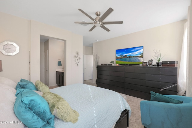 carpeted bedroom with connected bathroom and ceiling fan