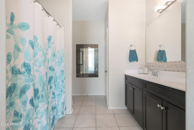 bathroom with tile patterned flooring, vanity, and walk in shower