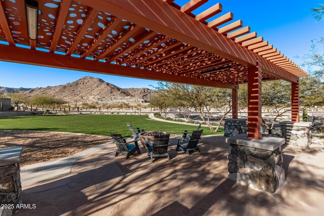 21186 W Hillcrest Blvd, Buckeye, AZ 85396 - view of patio with a mountain view, a pergola, and a fire pit