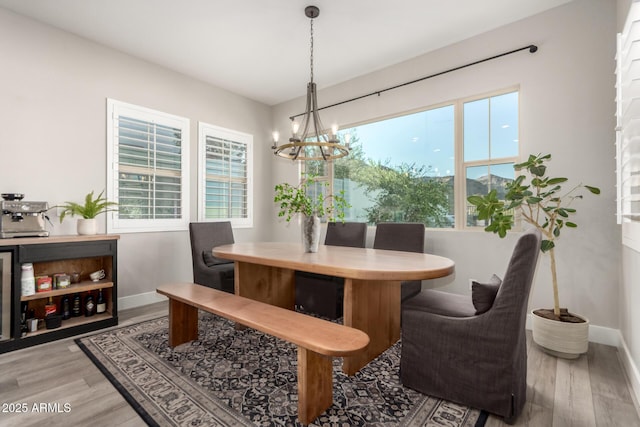 21186 W Hillcrest Blvd, Buckeye, AZ 85396 - dining room with a chandelier, baseboards, and wood finished floors