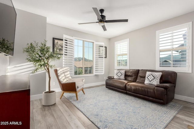 21186 W Hillcrest Blvd, Buckeye, AZ 85396 - living room featuring baseboards, ceiling fan, and wood finished floors