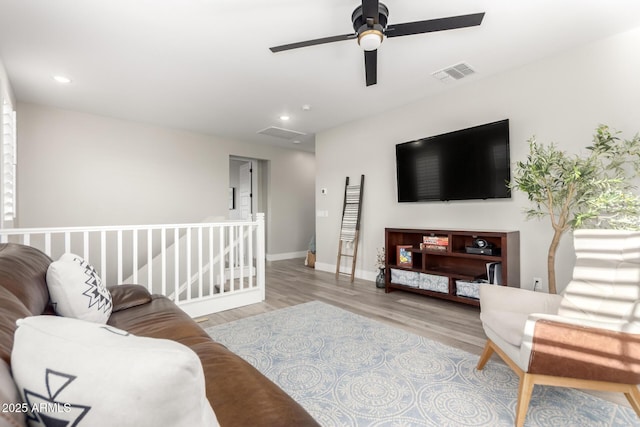 21186 W Hillcrest Blvd, Buckeye, AZ 85396 - living room featuring wood finished floors, ceiling fan, baseboards, and recessed lighting