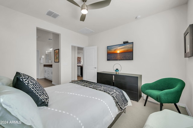 bedroom with connected bathroom, ceiling fan, and light colored carpet