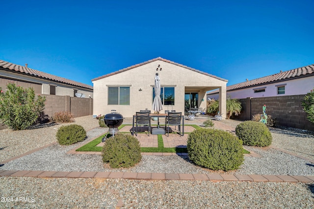 rear view of property featuring a patio area