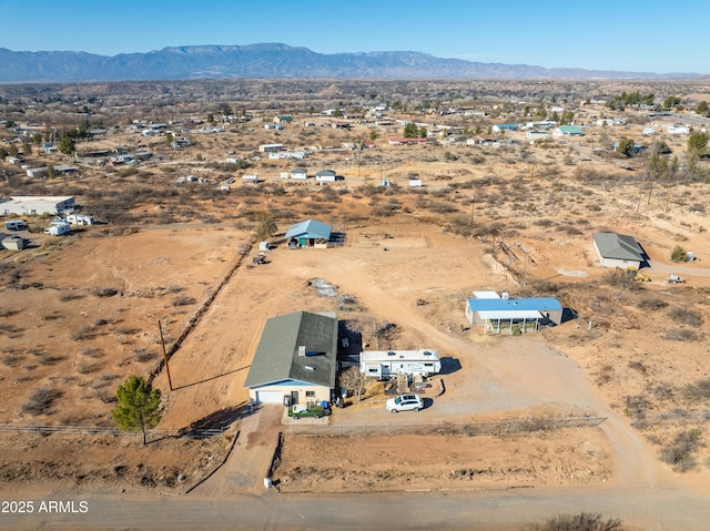 drone / aerial view with view of desert and a mountain view