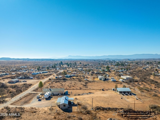 drone / aerial view with a desert view, a rural view, and a mountain view