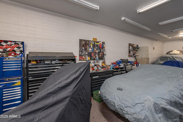 bedroom with a workshop area and brick wall