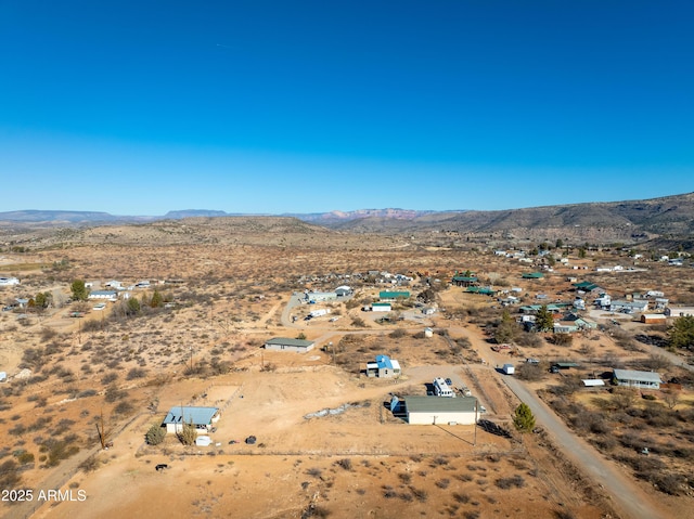 aerial view featuring a mountain view and a desert view