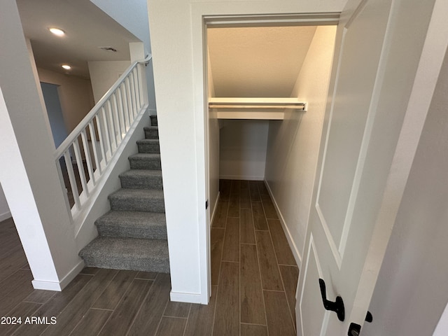 stairway with hardwood / wood-style floors