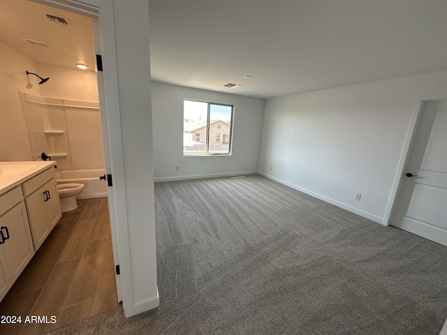 interior space with connected bathroom and light carpet