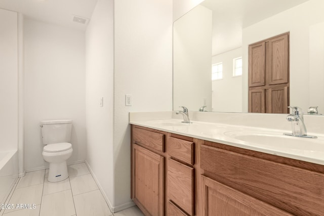 bathroom featuring vanity, tile patterned floors, a bathtub, and toilet