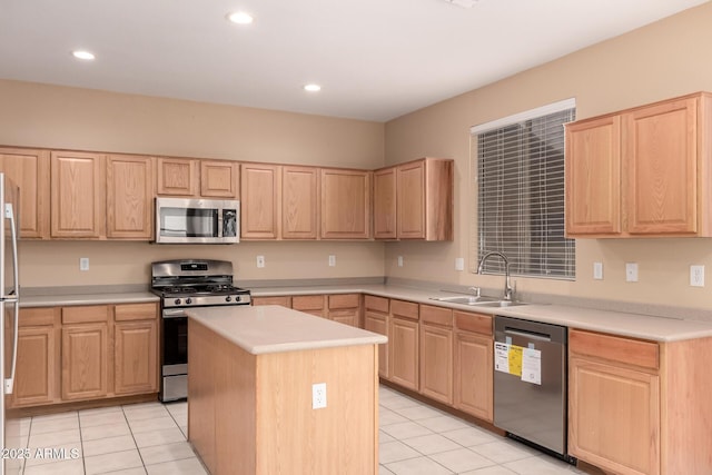 kitchen with a kitchen island, appliances with stainless steel finishes, and light brown cabinetry