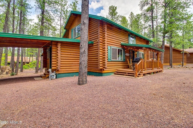 rear view of property with a carport