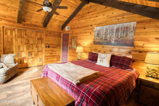 bedroom featuring high vaulted ceiling, ceiling fan, beamed ceiling, light hardwood / wood-style floors, and wood ceiling