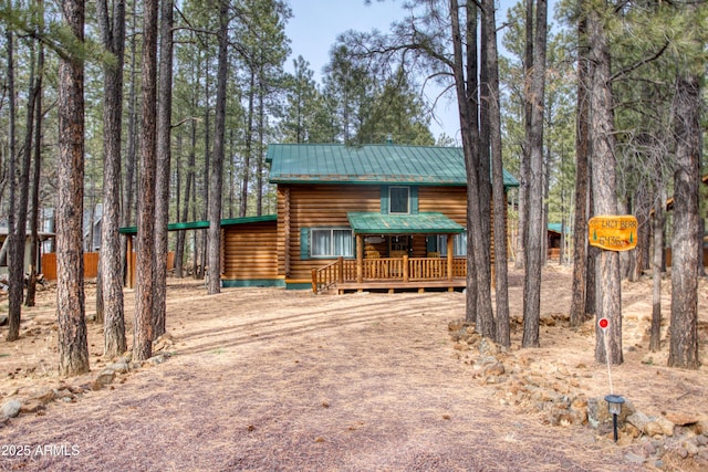 log-style house featuring a wooden deck