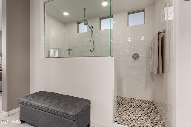 bathroom with tile patterned floors and a tile shower