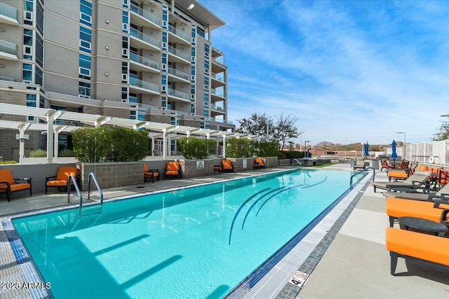 view of swimming pool featuring a pergola