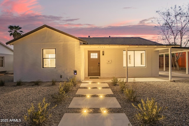 view of front of home featuring a patio and a fire pit