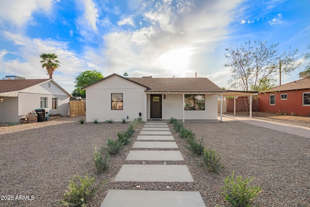 single story home with fence and a carport