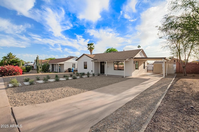 single story home with fence, a gate, a carport, and driveway