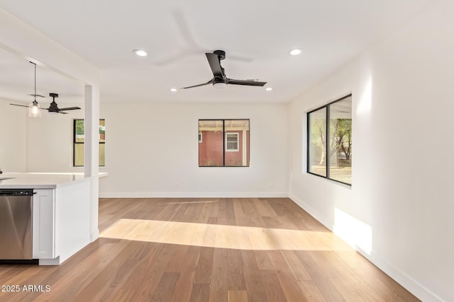 interior space with recessed lighting, a ceiling fan, and light wood-style flooring