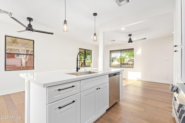 kitchen with a sink, ceiling fan, stainless steel appliances, and visible vents
