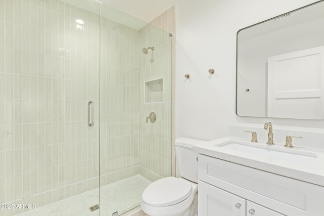 full bathroom with vanity, toilet, and a stall shower