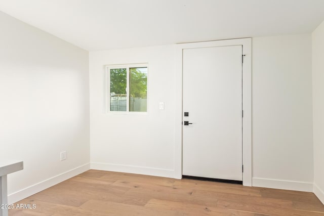 interior space featuring baseboards and light wood-style flooring