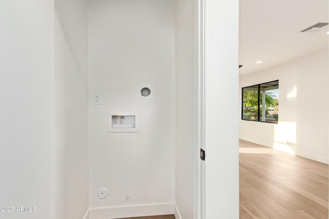 washroom featuring visible vents, hookup for a washing machine, hookup for a gas dryer, and light wood-type flooring
