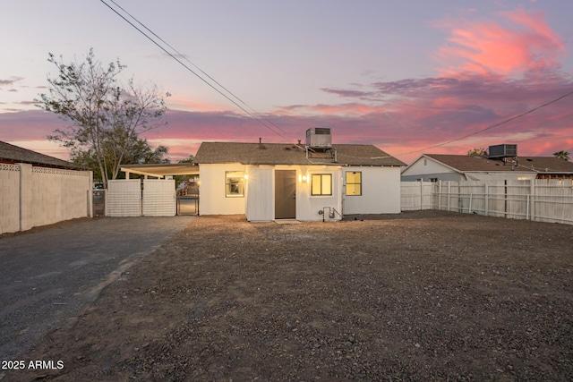 view of front of home with cooling unit, a gate, a fenced backyard, and aphalt driveway