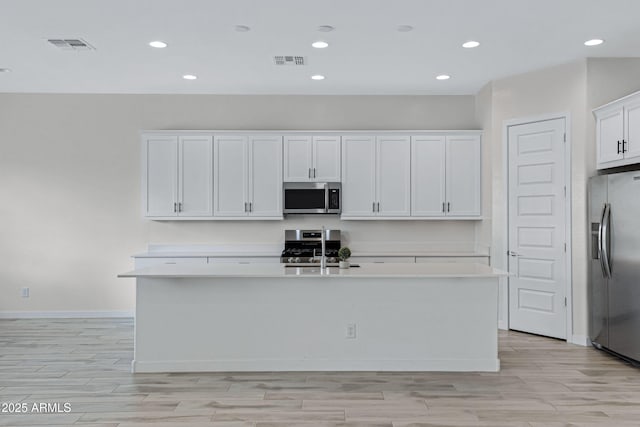 2968 E Tundra Ln, San Tan Valley, AZ 85143 - kitchen with an island with sink, visible vents, light countertops, and stainless steel appliances
