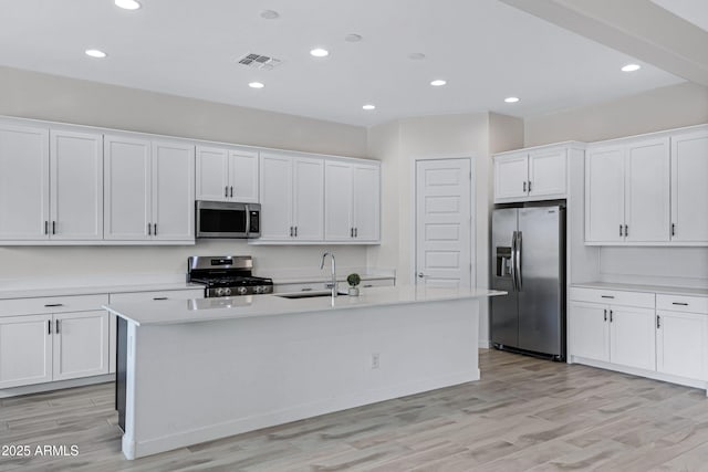 2968 E Tundra Ln, San Tan Valley, AZ 85143 - kitchen featuring light countertops, stainless steel appliances, a sink, an island with sink, and white cabinets