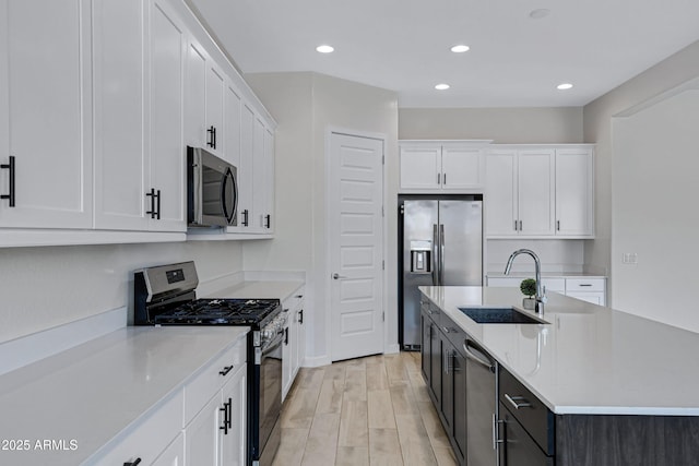 2968 E Tundra Ln, San Tan Valley, AZ 85143 - kitchen with white cabinetry, a sink, a kitchen island with sink, and appliances with stainless steel finishes
