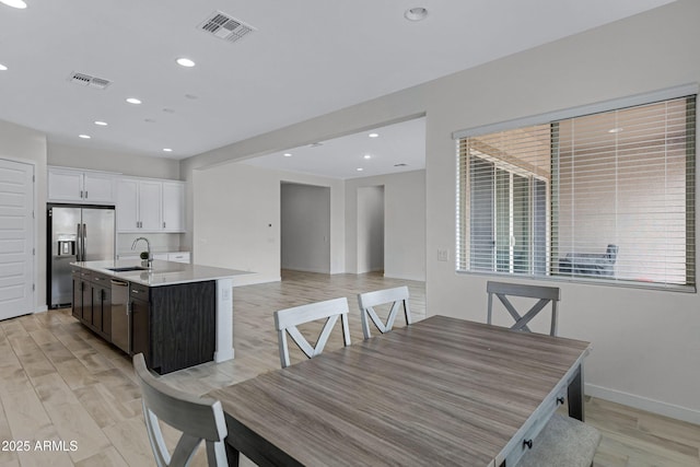 2968 E Tundra Ln, San Tan Valley, AZ 85143 - dining area with light wood finished floors, visible vents, and recessed lighting