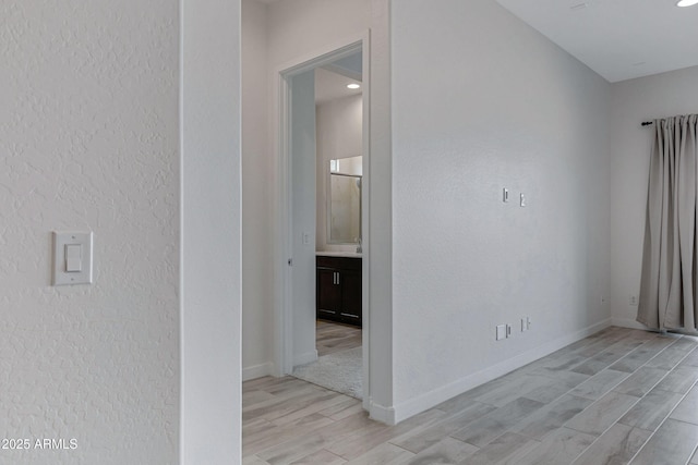 2968 E Tundra Ln, San Tan Valley, AZ 85143 - interior space with baseboards, light wood-style flooring, and a textured wall